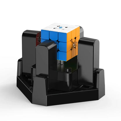 Smart speed cube in black charging dock, featuring blue and orange sides, designed for fast puzzle solving.