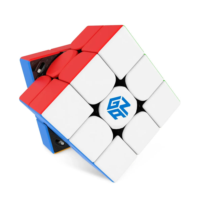 GanCube 11M Pro black internal mechanism with stickers featuring red, white, blue, and green sides
