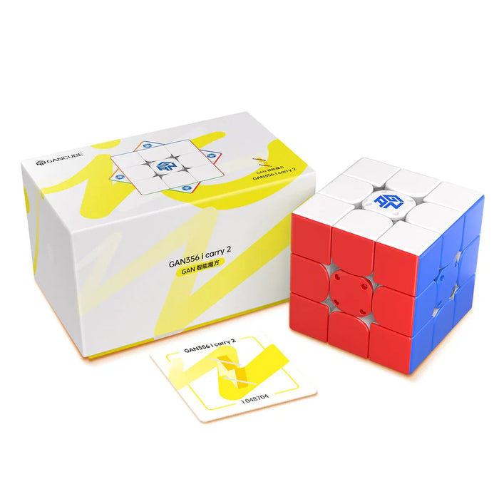 GAN356 i carry 2 magnetic 3x3 speed cube with white, red, and blue stickers next to branded box and warranty card