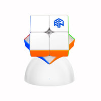 GANCUBE 2x2 magnetic speed cube on a white stand, featuring colored stickers and brand logo.