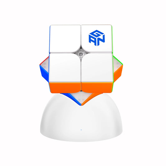 GANCUBE 2x2 magnetic speed cube on a white stand, featuring colored stickers and brand logo.