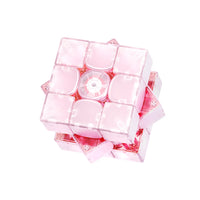 Pink translucent speed cube with glowing core, showcasing advanced smart cube design for speedcubing enthusiasts.