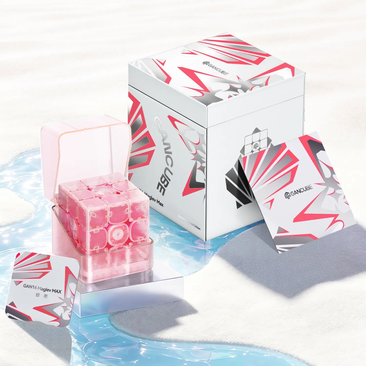 Pink GAN16 Maglev MAX speed cube in clear case with branded box and cards on sandy beach