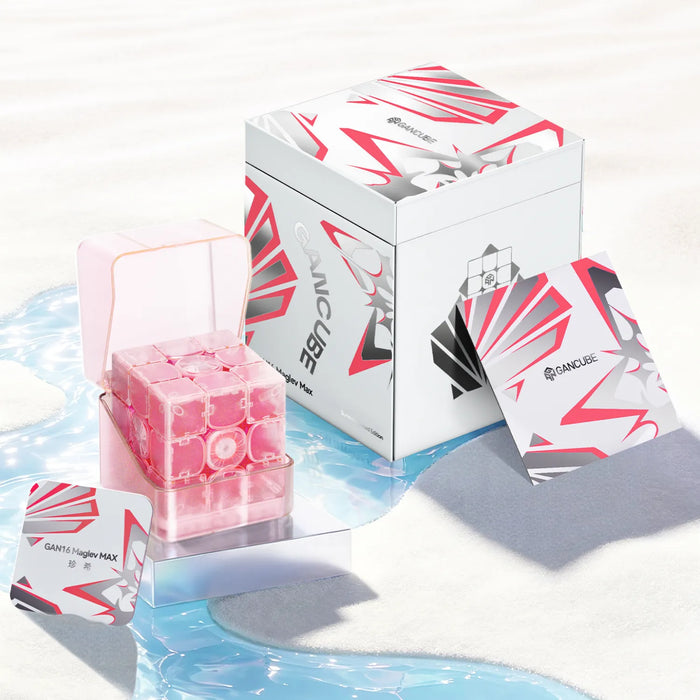 Pink GAN16 Maglev MAX speed cube in clear case with branded box and cards on sandy beach