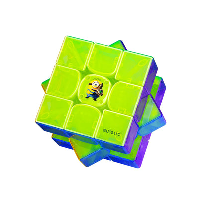 Minion-themed speed cube with vibrant green, blue, and purple translucent pieces, featuring a Minion character on center tile